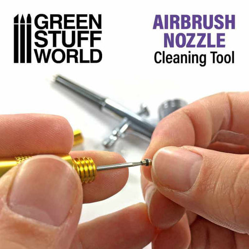 Hands holding airbrush nozzle cleaner